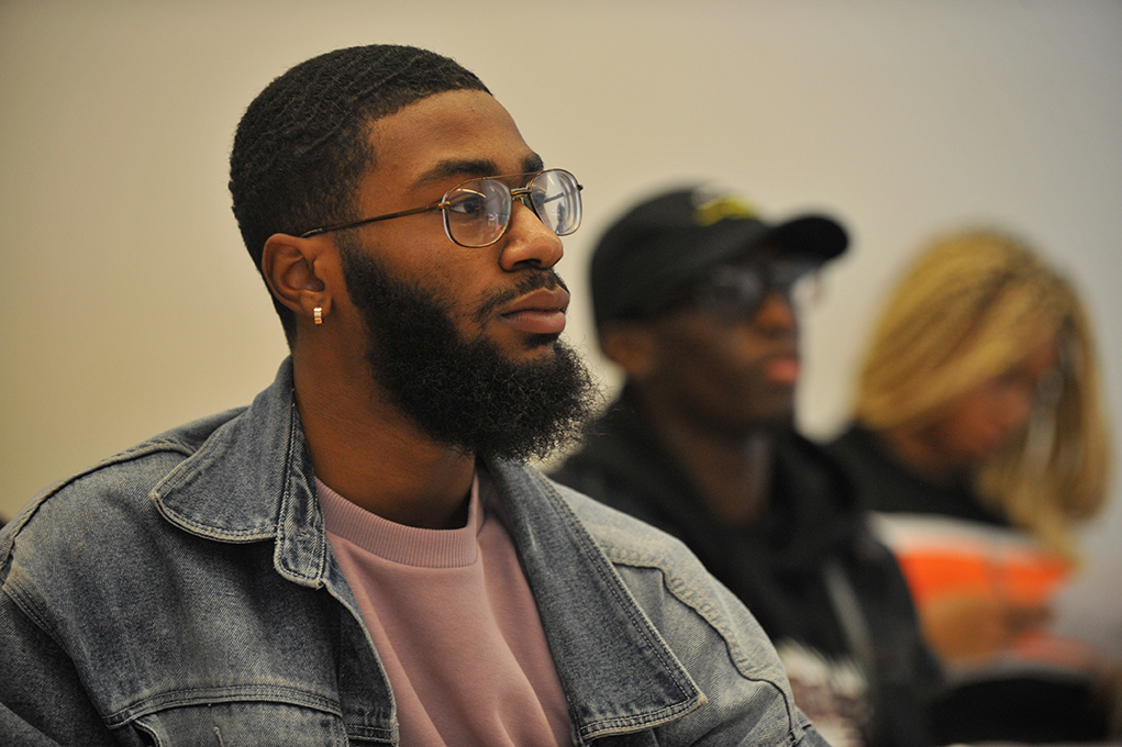 A student looking focused sitting in a classroom.