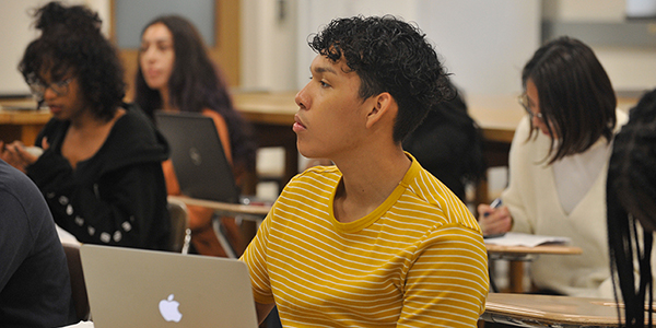 A student looking focused sitting in a classroom.