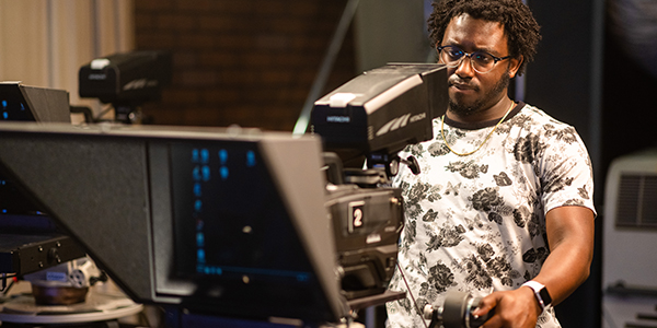 A student using media equipment.