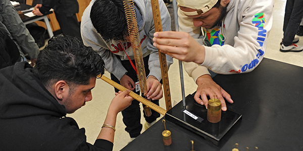 Three students working together in an engineering lab.