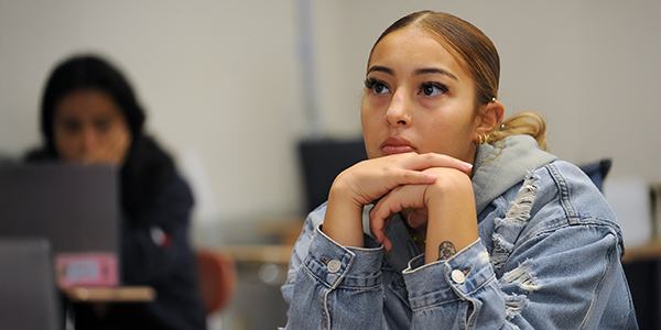 A student looking focused sitting in a classroom.