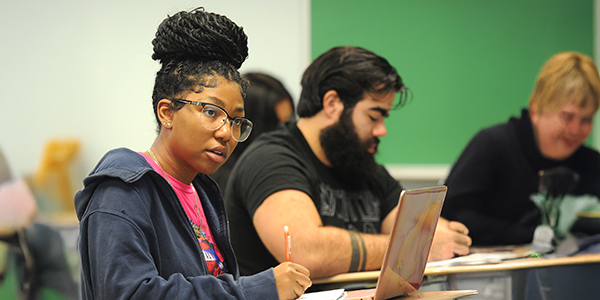 A student looking focused sitting in a classroom.