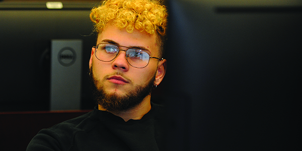 Picture of a student looking focused in class.