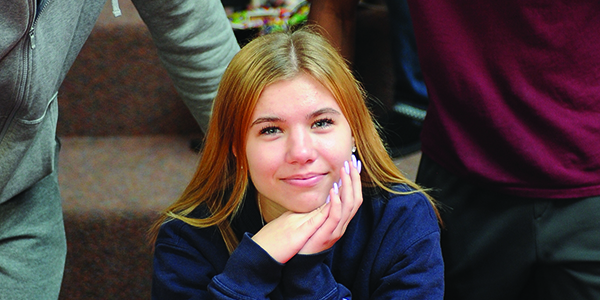 A student smiling at the camera.