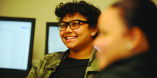 A student smiling in class.