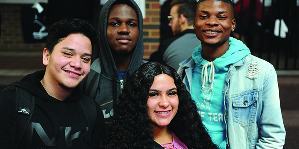 Four students smiling.