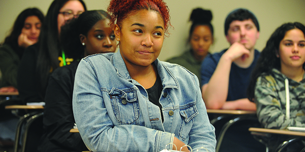 A student sitting in class looking forward.