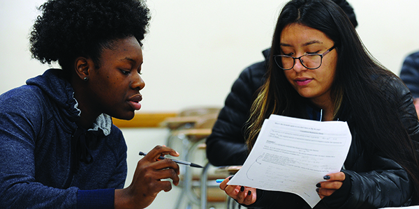 Two students working together on an assignment in class.