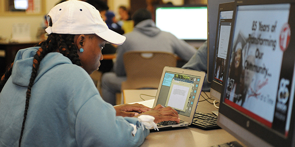 A student working on a laptop.