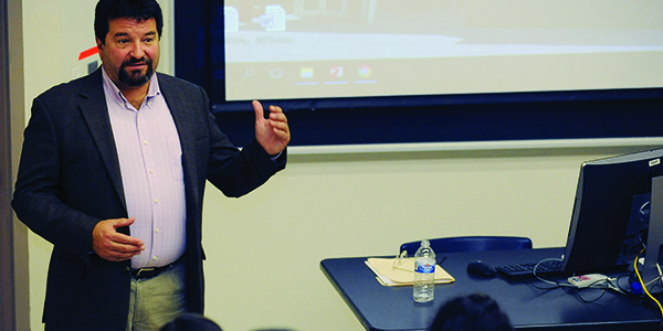 A professor teaching in front of the classroom.