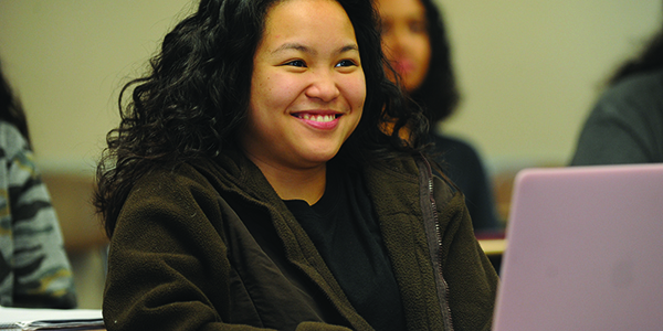 A student smiling in class.