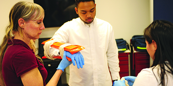 A professor demonstrating Emergency Medical Studies techniques.