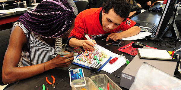 Two students working together in an engineering lab.