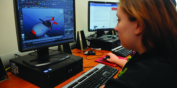 A student working on a design on a desktop computer.