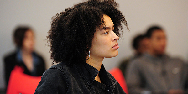 A student looking focused sitting in a classroom.