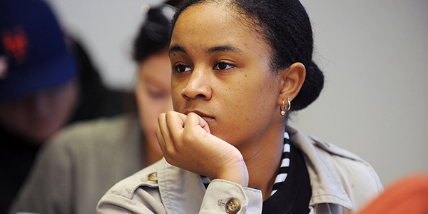A student looking focused sitting in a classroom.