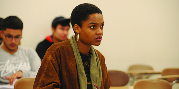 A student looking focused sitting in a classroom.