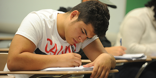 A student writing in class.
