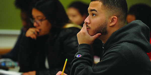 A student looking focused sitting in a classroom.